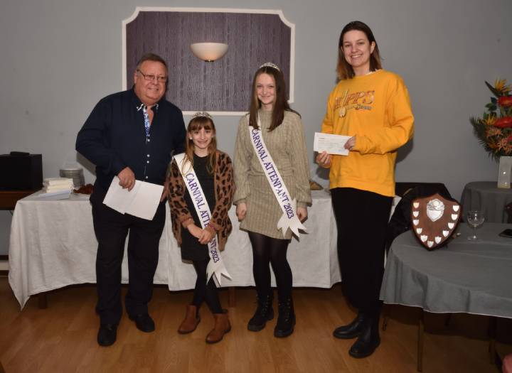 Chairman Graham Davies ably helped by Bridport Royalty Attendants, presenting a cheque to Jodie Glover, on behalf of Bridport Musical Theatre Company.