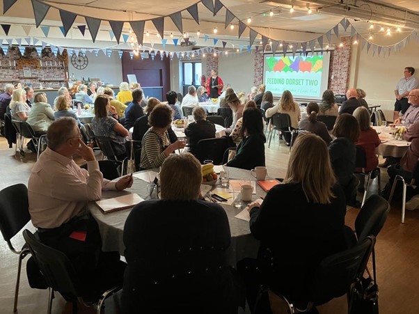 Discussions about food resilience and food networks in Dorset at the Feeding Dorset Two event in 2023.
