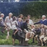 The photo is from the collection of Jill Mapstone and shows children on the village green, Bernards' Place, which was gifted by Lady Pinney (the older woman in the photo) and is named in memory of her brother and son, who were both called Bernard.